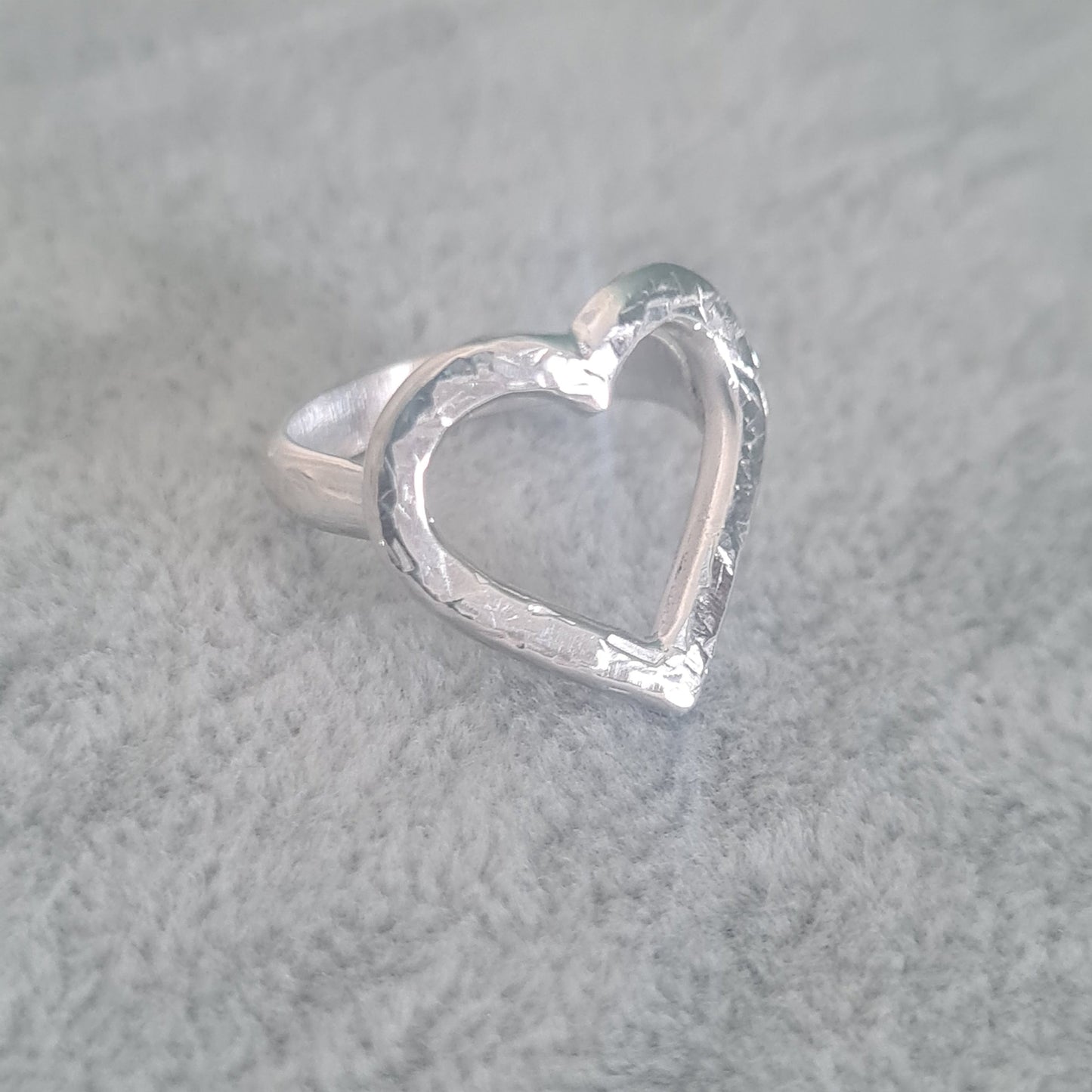 Sterling silver ring with open heart design and hammered texture