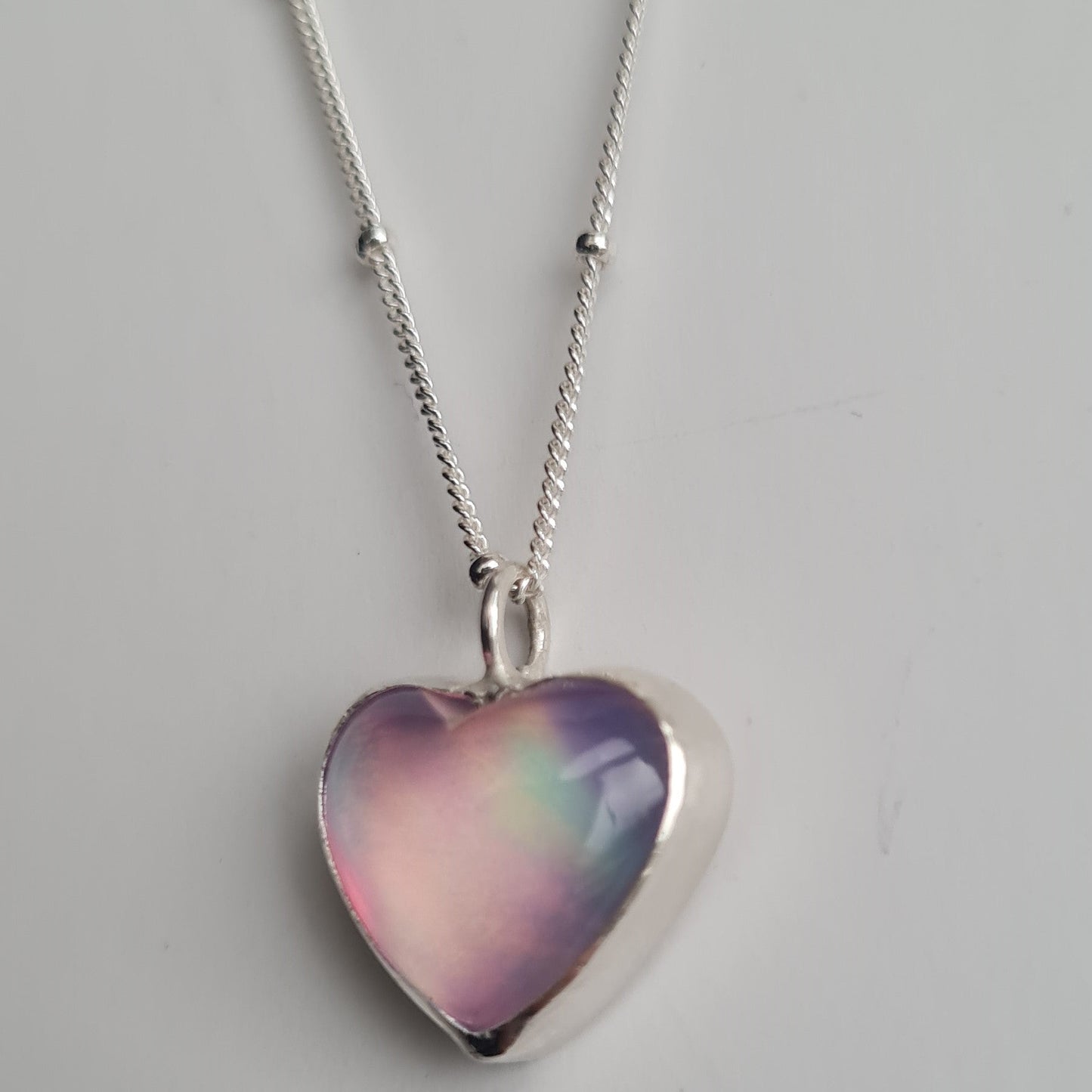 Heart shaped aurora heart pendant in sterling silver on silver satellite chain