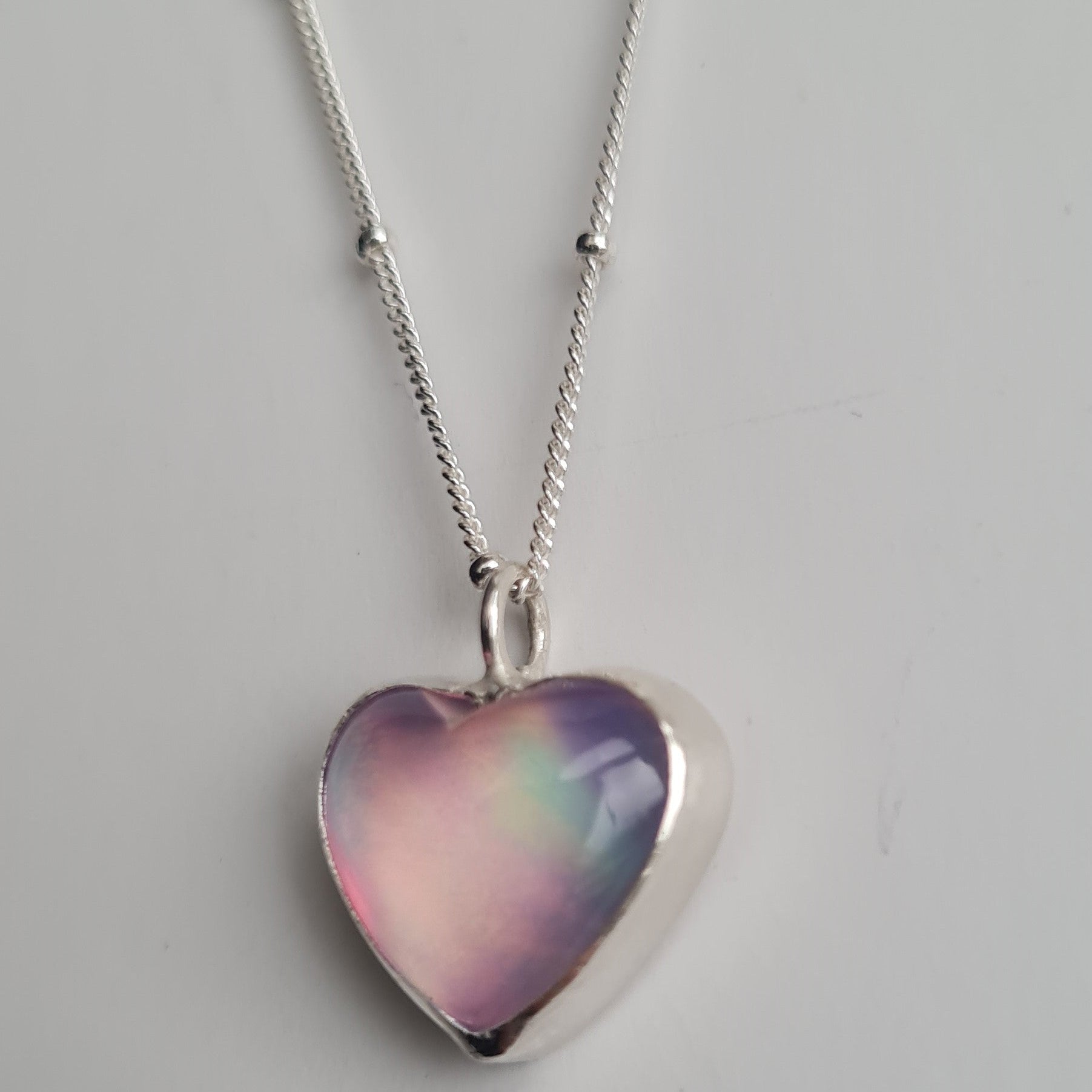 Heart shaped aurora heart pendant in sterling silver on silver satellite chain