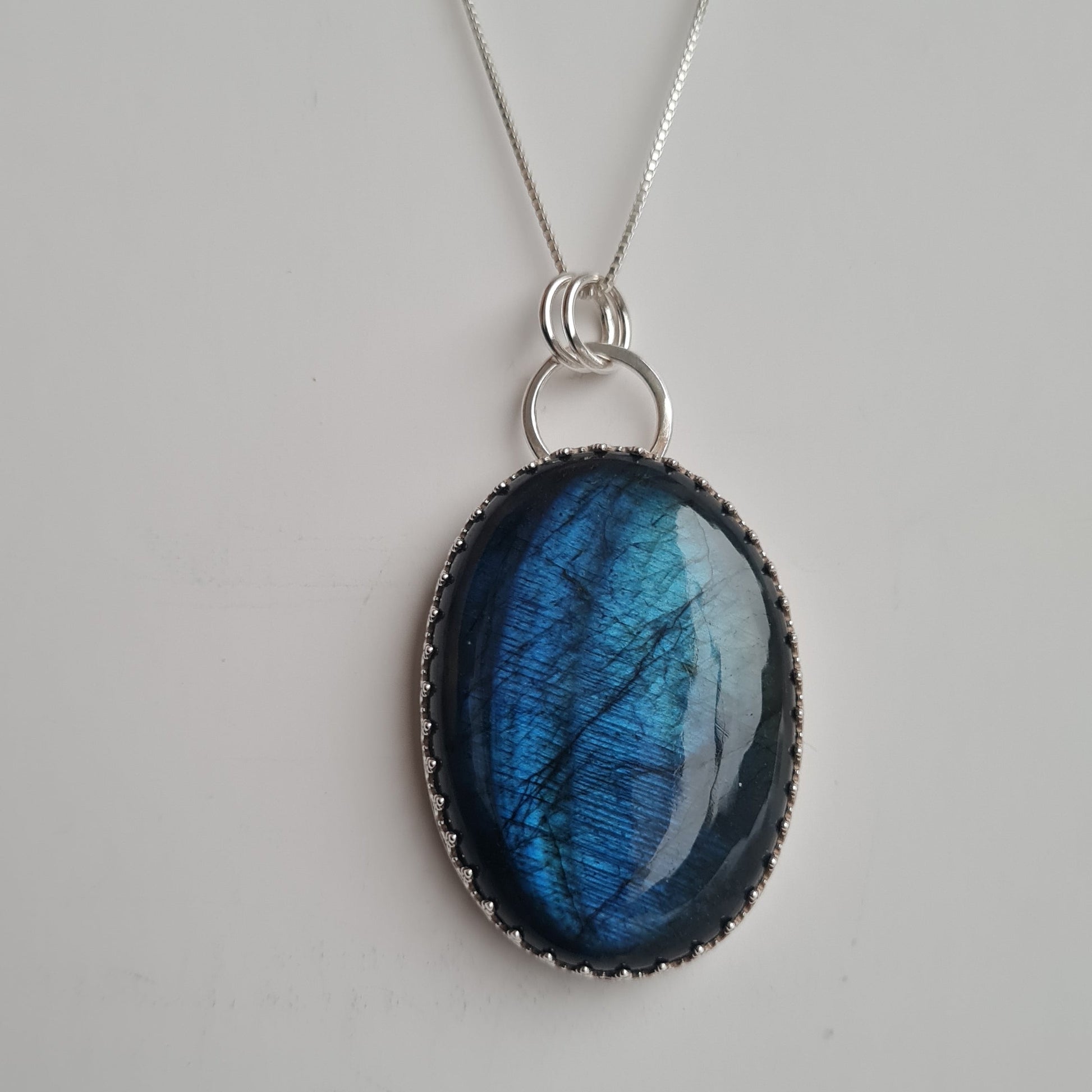 Blue labradorite gemstone pendant on a silver chain