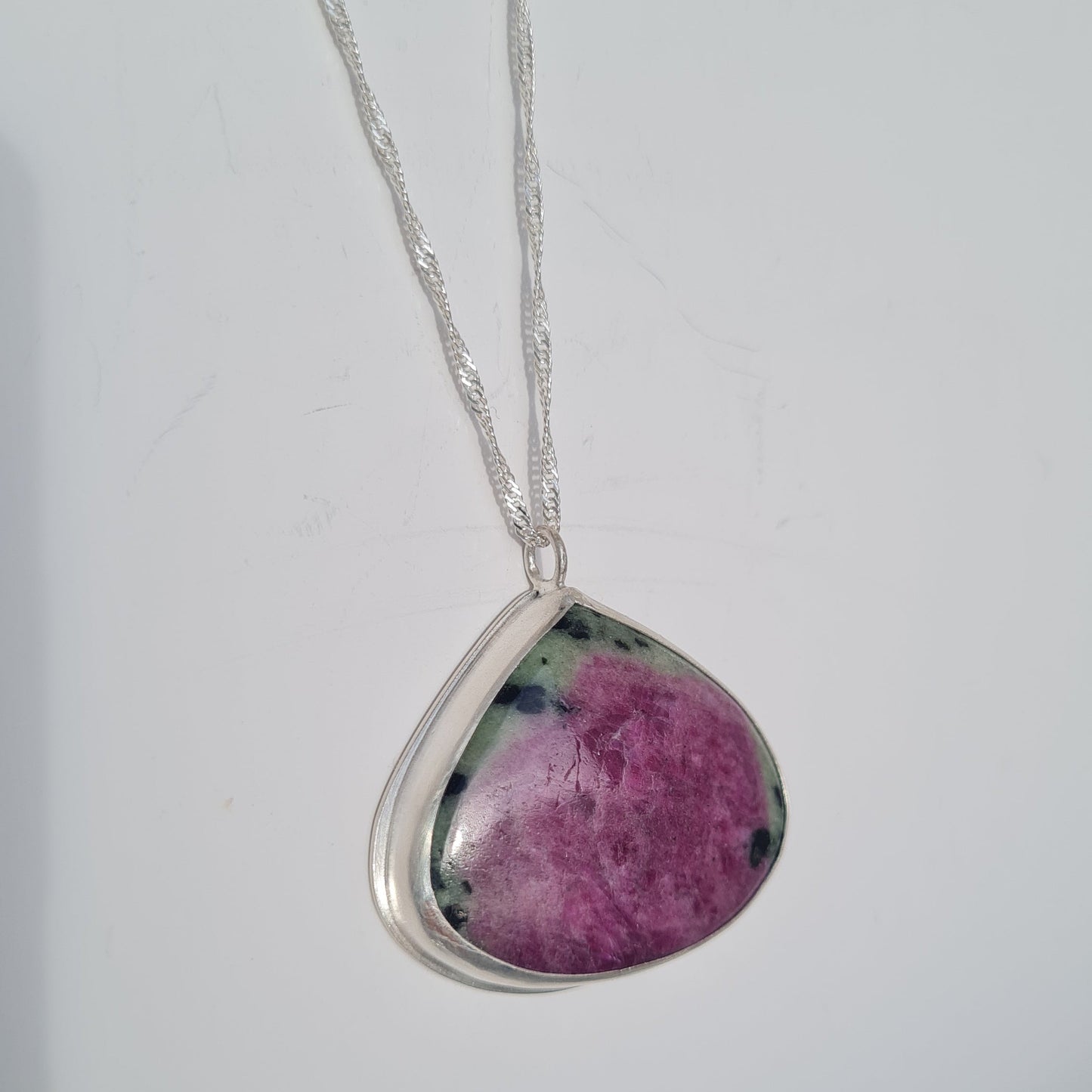 Sterling silver bezel pendant with Ruby Zoisite stone in purple and green. On silver chain
