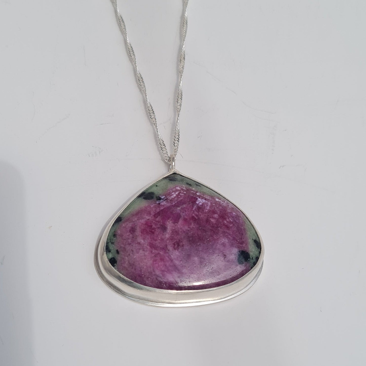 Sterling silver bezel set pendate with ruby Zoisite stone in purple and green, on silver chain