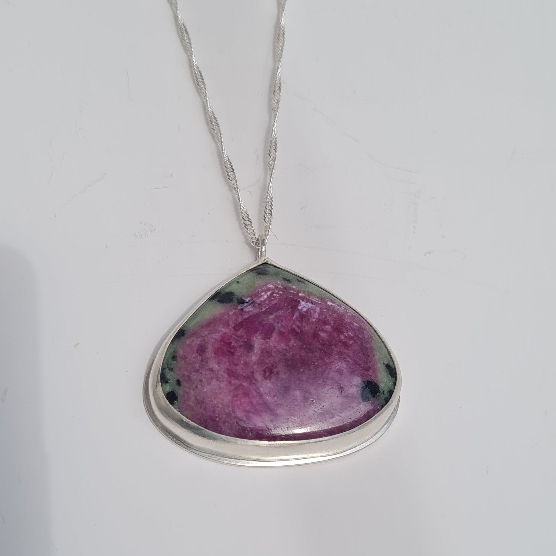 Sterling silver bezel set pendate with ruby Zoisite stone in purple and green, on silver chain