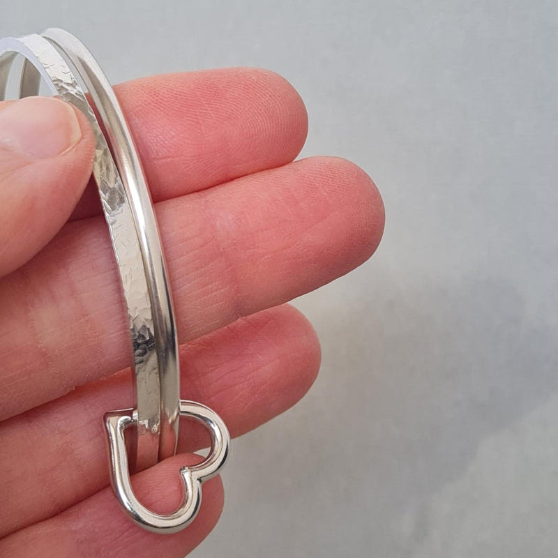 sterling silver stacking bangles with textured silver and silver heart charm