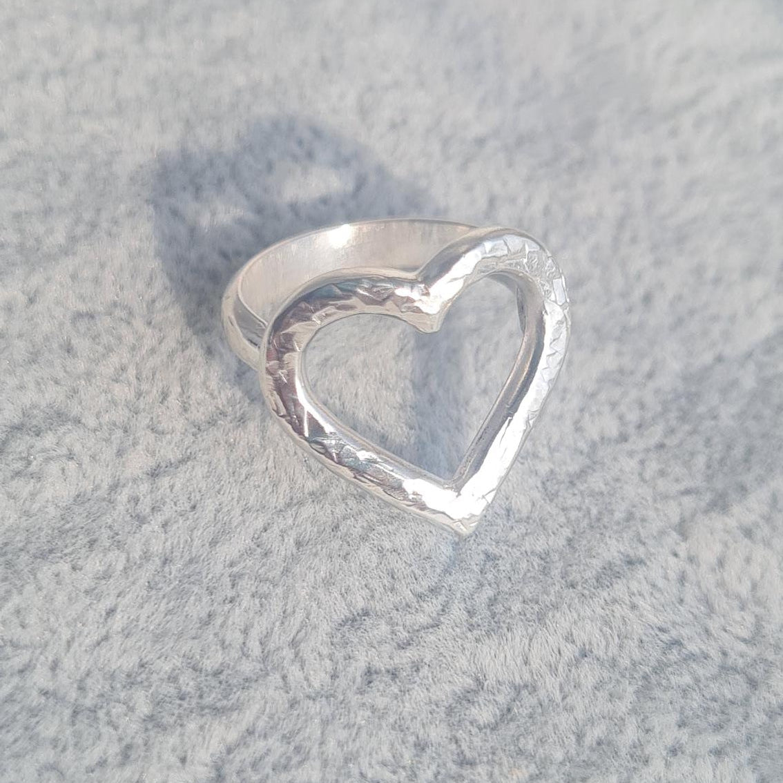 Sterling silver ring with open heart design and hammered texture