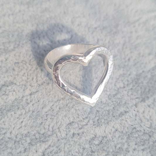 Sterling silver ring with open heart design and hammered texture